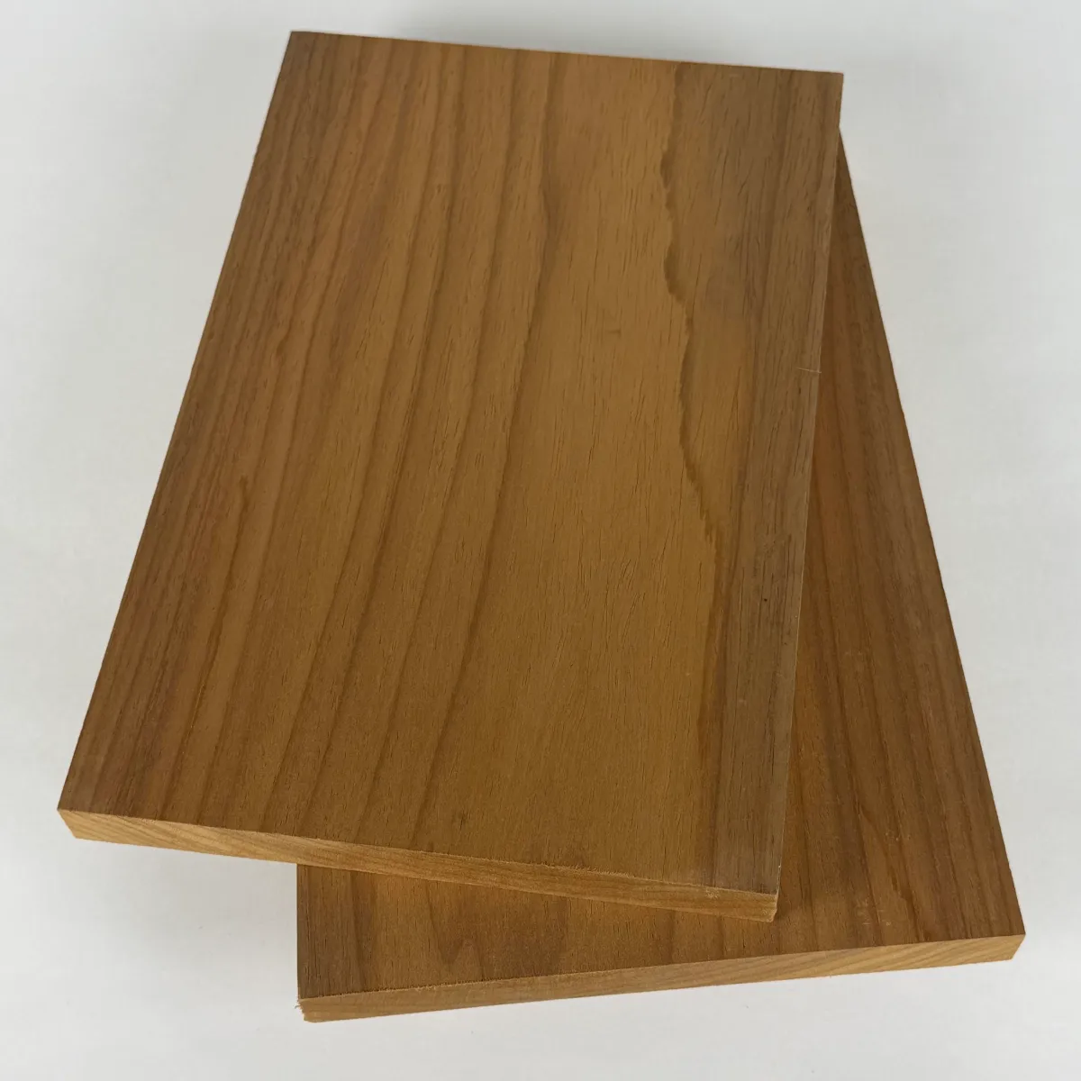 Nova Ambara® 1x8 S4S thermally modified hardwood boards stacked on a white studio background, showing the full width of the surfaced face.
