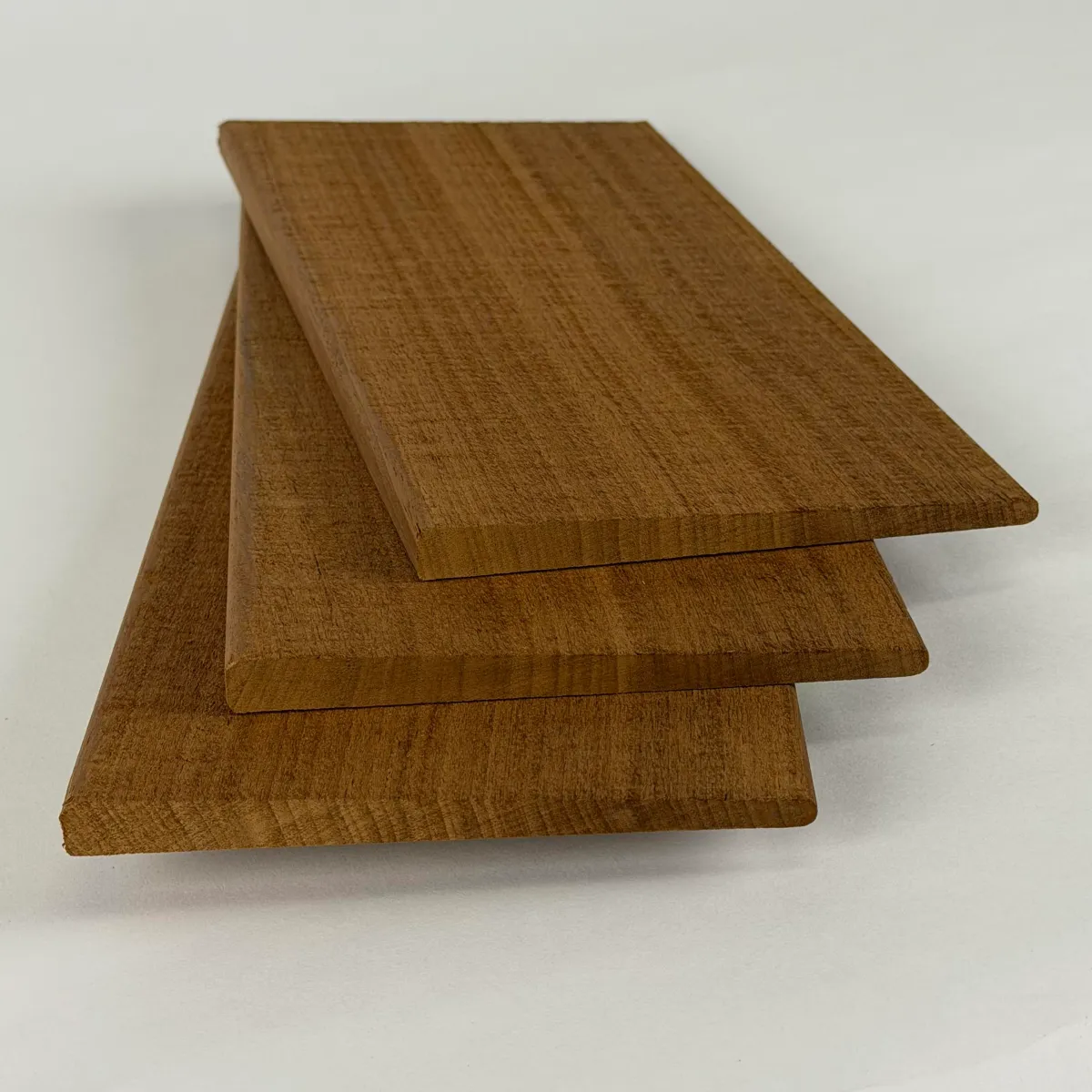 Three Nova Ambara® 1/2x6 bevel siding boards stacked on a white studio background, showing the taper from butt to tip.