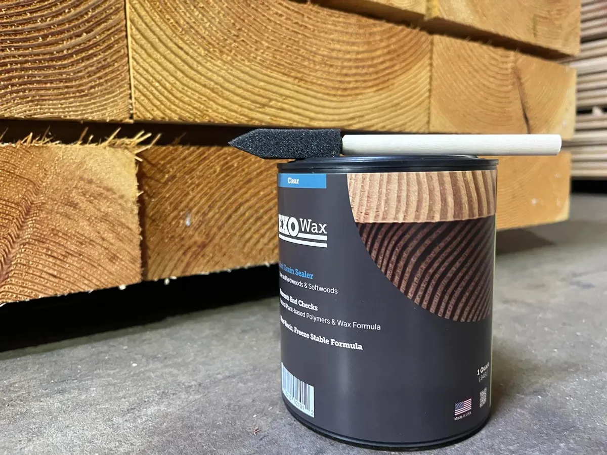 Applying ExoWax with a foam brush to sawn timber ends